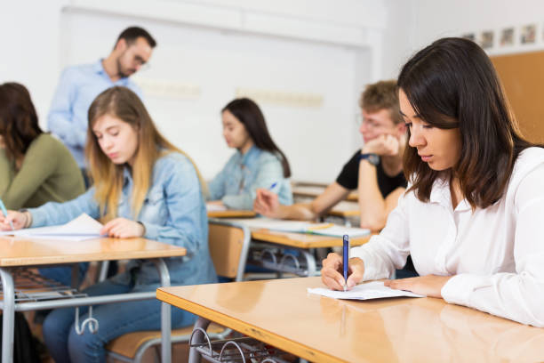 istock schoolgirl is sitting test and answer about task 1306202254
