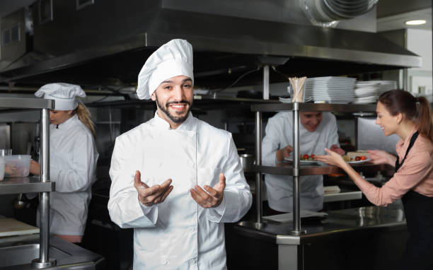 istock Portrait of satisfied smiling chef on restaurant kitchen 1306202409
