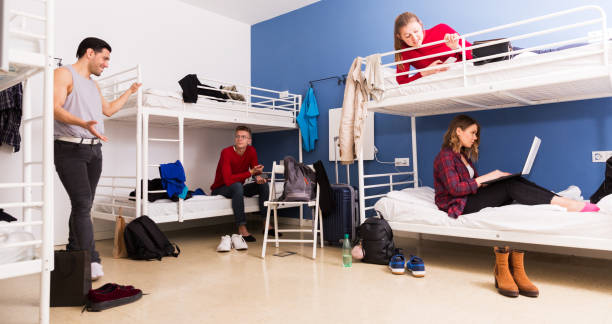 istock Travelers communicating in hostel bedroom 1306202484