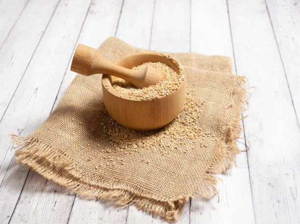 istock white sesame seeds, sesame seeds in a wooden spoon 1306203125