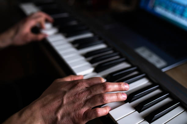 istock A cropped shot of a man's hands playing the keyboard 1306204688
