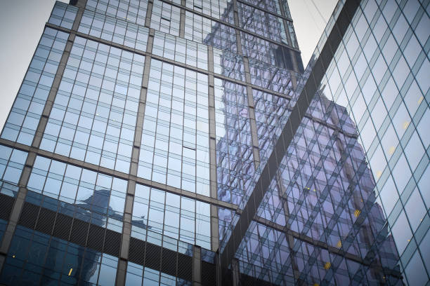 istock Reflection of skyscraper in a glass facade of building 1306208317
