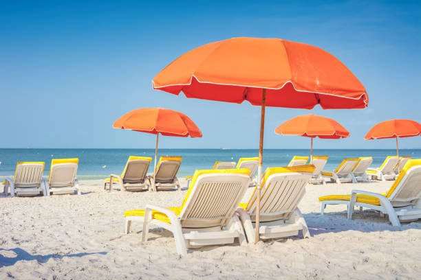 istock Beach with Lounge Chairs and Umbrella 1306208549