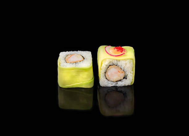 istock sushi rolls on a black background, japanese cuisine 1306209196