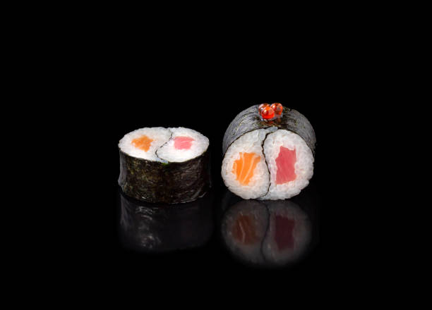 istock sushi rolls on a black background, japanese cuisine 1306209204
