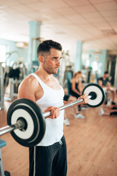 istock man doing barbell at the gym 1306209304