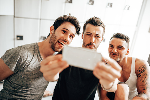 friends take a selfie in the locker room