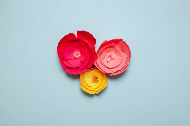 istock Paper cutout flowers on blue background. 1306210408