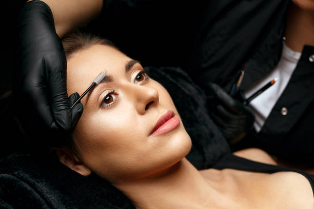 istock Beauty specialist combing eyebrows with a brush 1306213583
