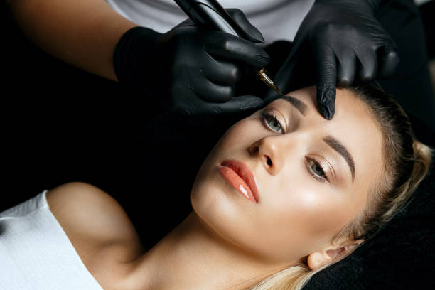 istock Woman in gloves applying permanent makeup 1306213684