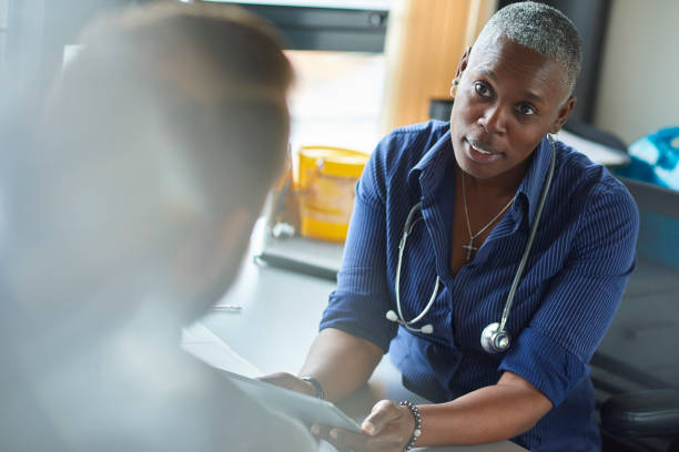 concerned gp medical consultation with female doctor doctor general practitioner stock pictures, royalty-free photos & images