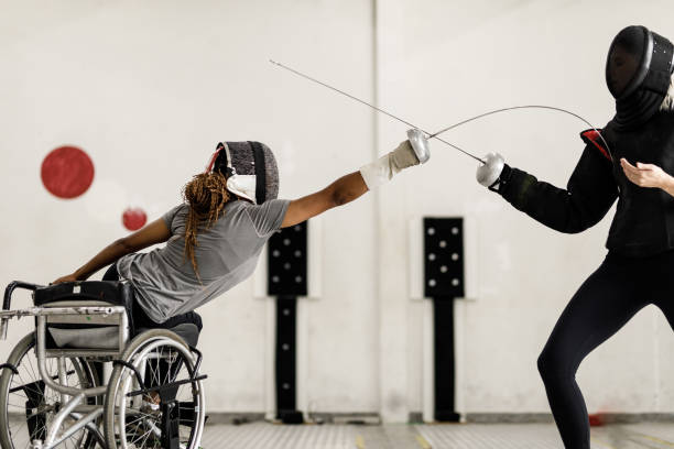 Female wheelchair fencer athlete attacking her coach during training