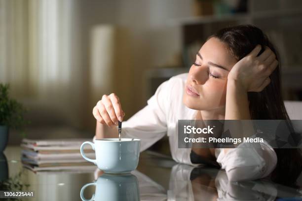 Sleepy Woman Stirring Coffee In The Morning Stock Photo - Download Image Now - Tired, Exhaustion, Coffee - Drink