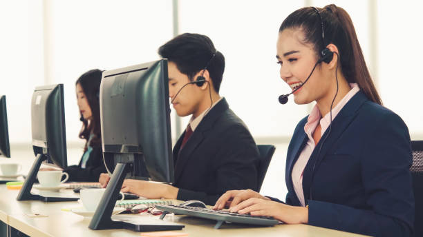 istock Business people wearing headset working in office 1306227960