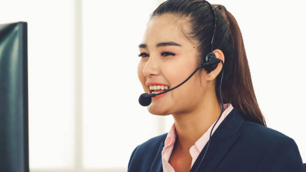 istock Business people wearing headset working in office 1306228127