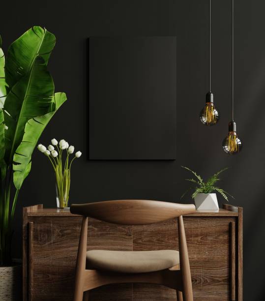 Mockup black frame on work table in living room interior on empty dark wall background.