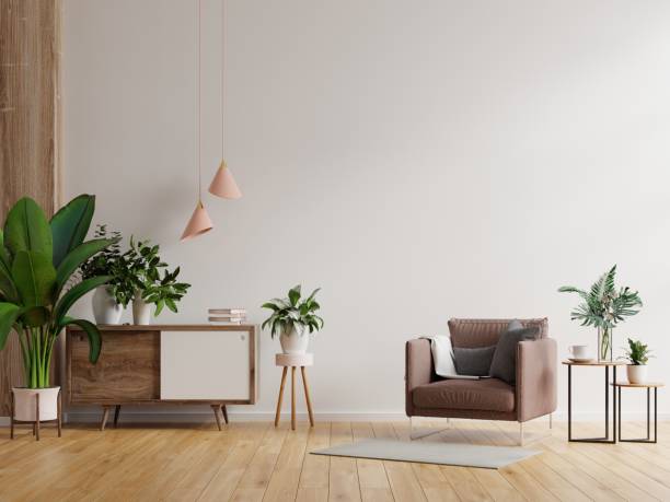 istock Modern minimalist interior with an armchair on empty white wall background. 1306229769