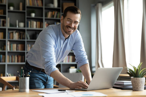 istock Successful business owner standing in office smile look at camera 1306230749