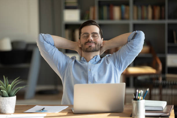 istock Serene businessman lean on office chair resting at workplace 1306230766