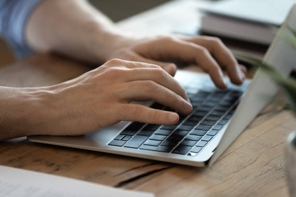 istock Male hands typing e-mail close up view laptop keyboard 1306230774
