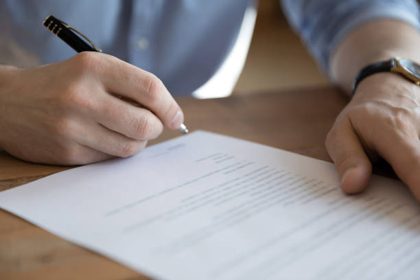 istock Bank client sitting at table sign loan application, closeup 1306230781