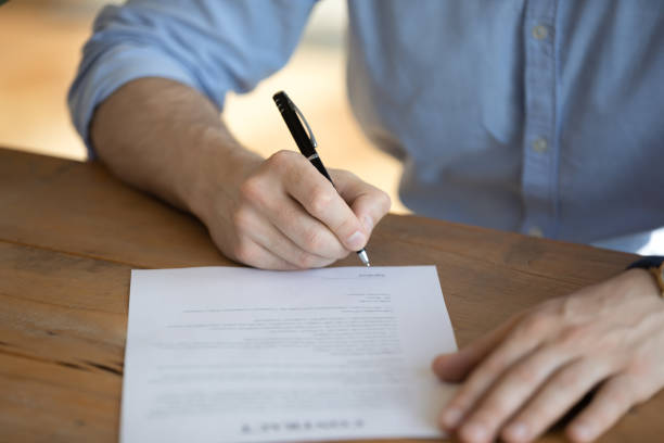 istock Hired employee signing employment contract, close up image 1306230785