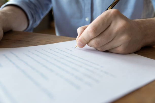 istock Man hand signing a contract, close up view 1306230791