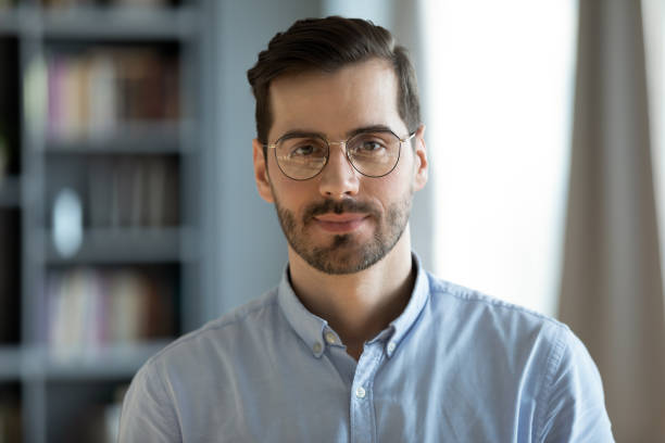 istock Headshot portrait businessman standing in modern office pose for camera 1306230802