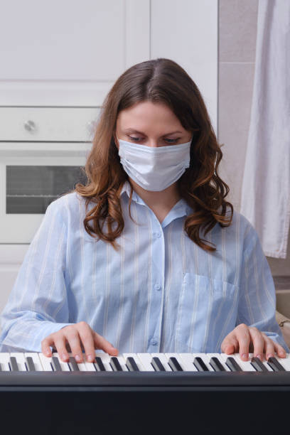 istock Piano lessons and playing a musical instrument in isolation during coronavirus quarantine 1306230945
