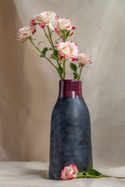 istock Bouquet of flower in Blue handmade ceramic vase on Blush textured table cloth. 1306232122