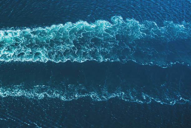 Ship's Wake Drone view of a ship's wake in open ocean. sea wake stock pictures, royalty-free photos & images
