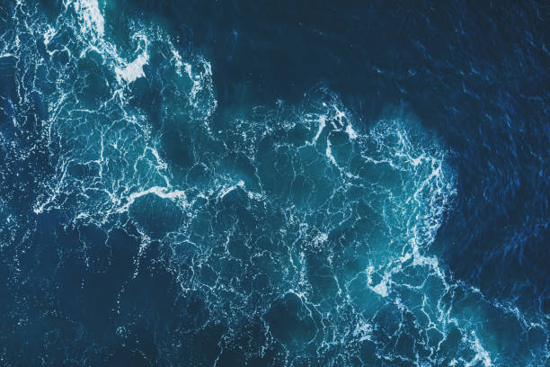 Ship's Wake Drone view of a ship's wake in open ocean. sea wake stock pictures, royalty-free photos & images