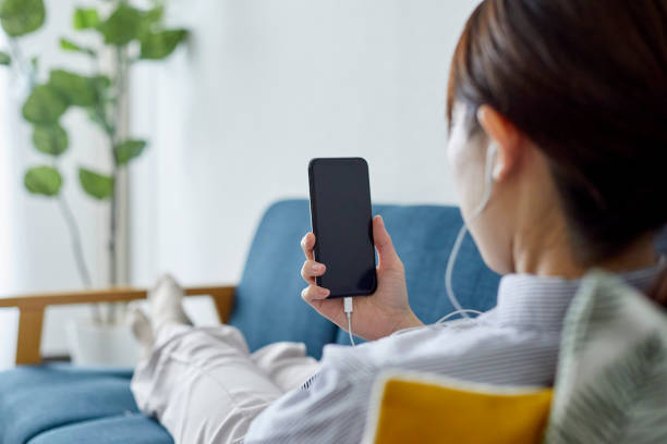 istock Young woman working with smartphone in living 1306235412