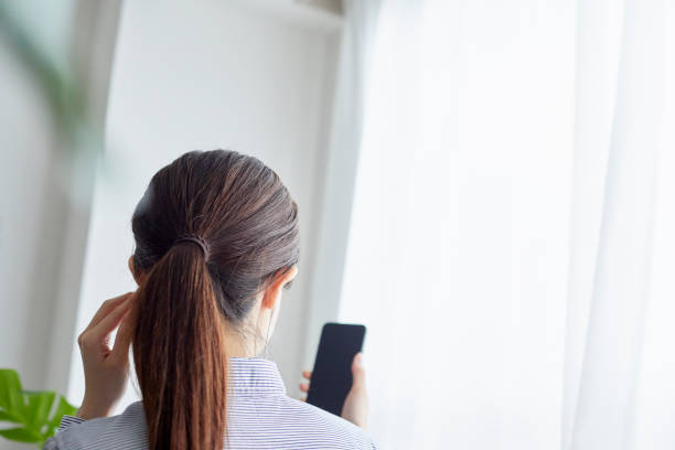 istock Young woman working with smartphone in living 1306235449