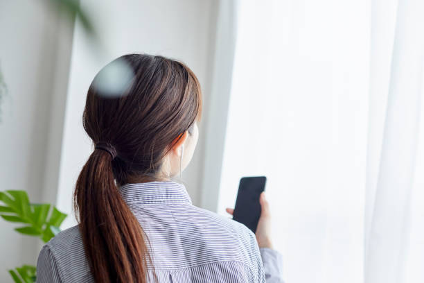 istock Young woman working with smartphone in living 1306235467