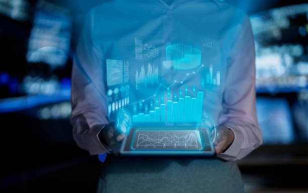 istock Business woman watching hologram growth graphs on a tablet computer 1306235490