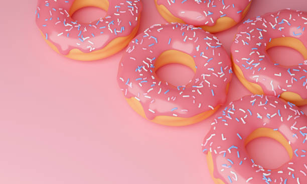 istock 3d cartoon sweet donuts covered with pink icing with sugar sprinkles on a pink background with place for text. Several voluminous delicious donuts on the surface. 3d illustration 1306237233