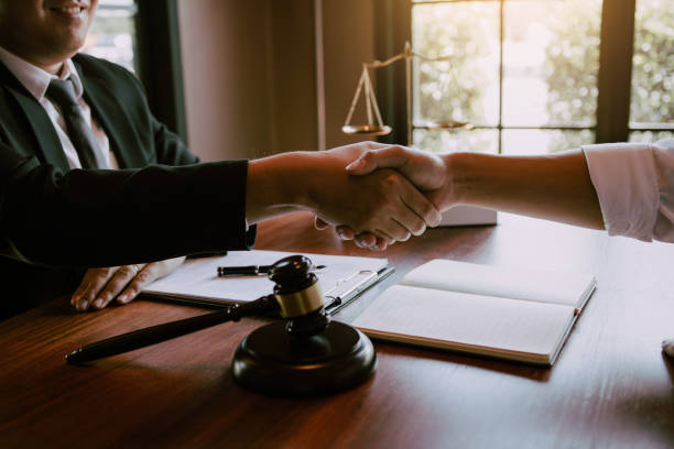 istock Lawyer is currently shaking hands with the client about the success in resolving the case. 1306239050