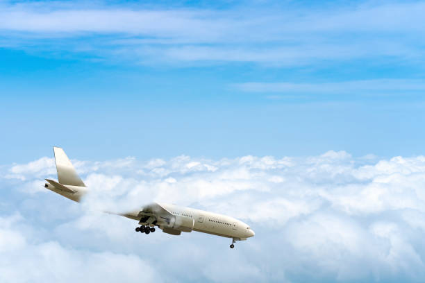 istock side image commercial passenger aircraft or cargo transportation airplane flying through white fluffy cloud with blue sky in bright day and spread the wheel prepare landing to airport 1306245309