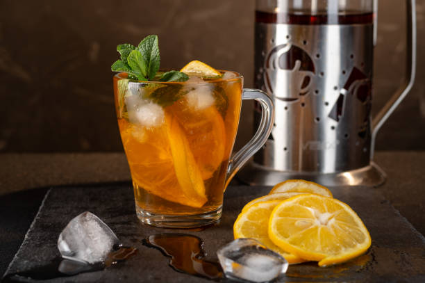 Teapot with tea. Mug with tea and zaarnik. Iced tea with lemon and ice.
