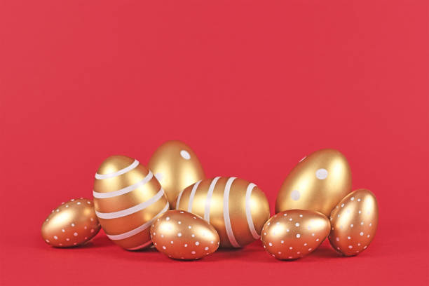 golden easter eggs with simple stripe and dot pattern on red background - easter eggs red imagens e fotografias de stock