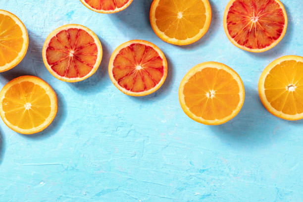 istock Summer background with fresh oranges on a blue background 1306250080