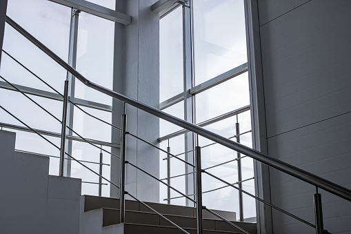 Staircase with metal railings by the window indoor