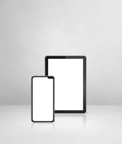 istock Mobile phone and digital tablet pc on white concrete office desk 1306251824