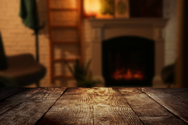 Empty wooden surface and blurred view of fireplace in room