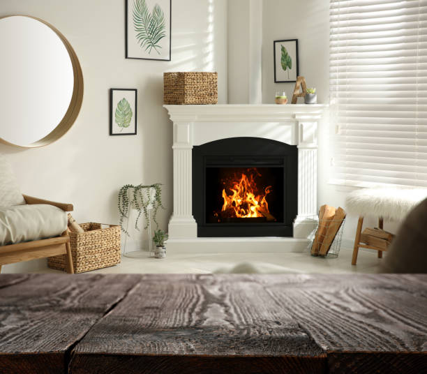 istock Empty wooden surface and blurred view of fireplace in room 1306254046