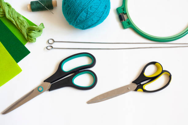 istock Creativity and needlework flat lay, scissors, skein of knitting thread, knitting needles, felt, spool of thread with needle and embroidery frame 1306254779