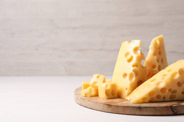 istock Tasty fresh cheese on white wooden table, closeup. Space for text 1306255517