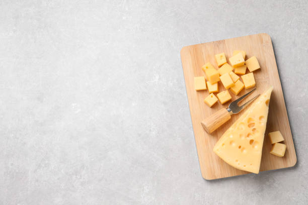 istock Tasty fresh cheese with fork on grey table, top view. Space for text 1306255619
