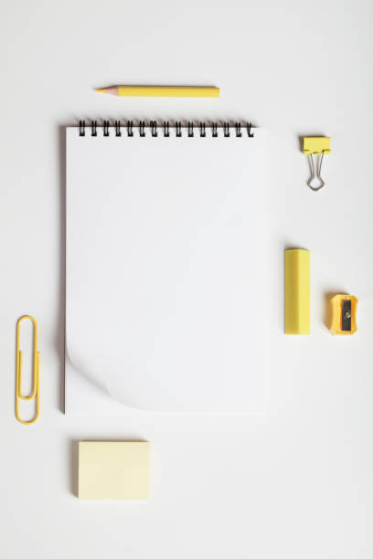 istock office table desk, workspace with notebook, yellow pencil, erasing, pencil sharpener and office supplies. Flat lay, top view, copy space. 1306259379